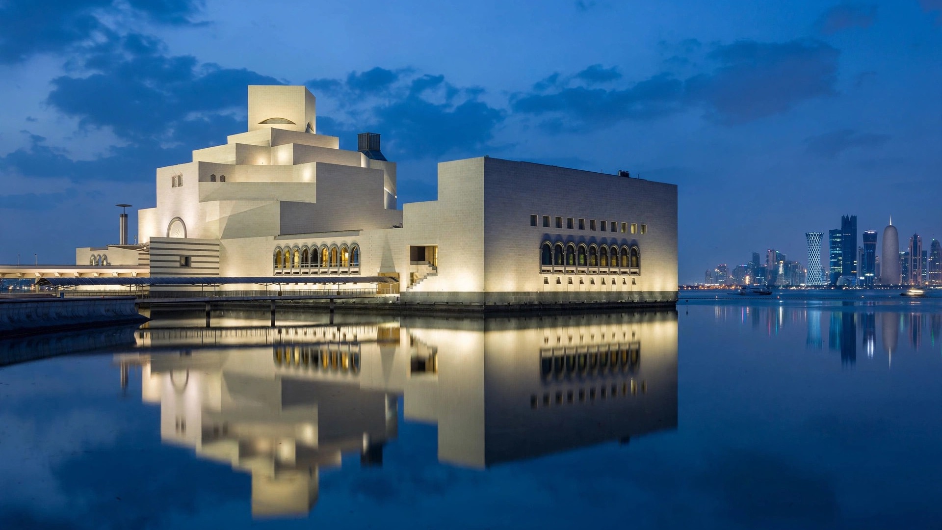 Museum of Islamic Art Doha with West Bay skyline at blue hour